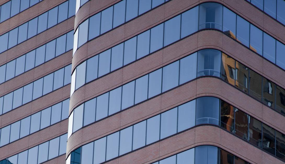 The side of a highrise building with glass windows